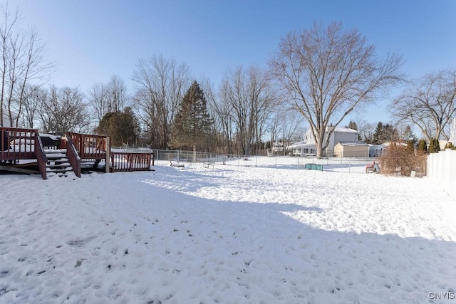 yard covered in snow featuring a wooden deck