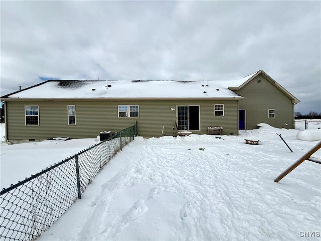 snow covered house featuring cooling unit