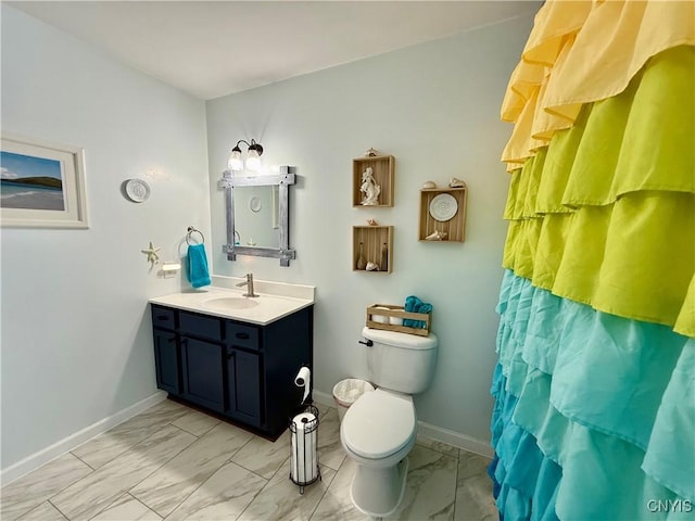 bathroom featuring vanity, curtained shower, and toilet