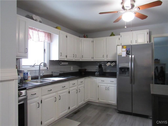 kitchen featuring sink, white cabinets, backsplash, and stainless steel fridge with ice dispenser