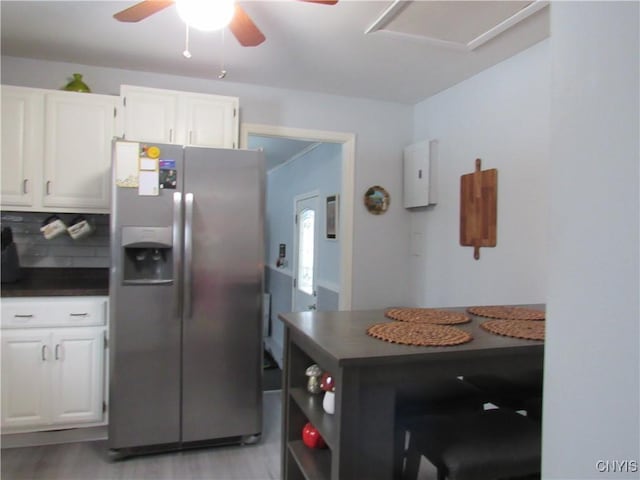 kitchen with white cabinetry, stainless steel refrigerator with ice dispenser, ceiling fan, and light hardwood / wood-style flooring