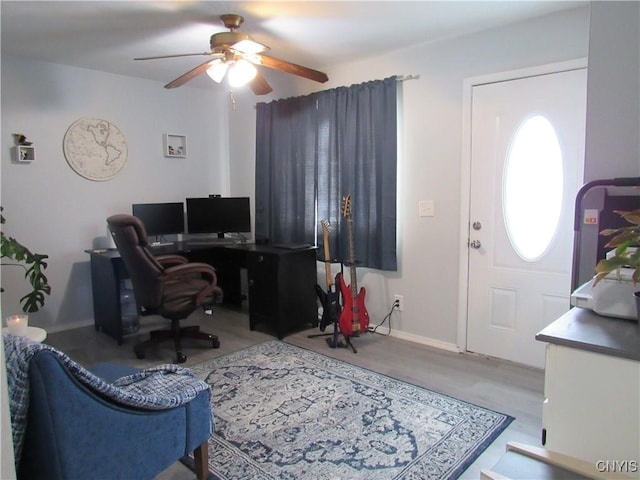 home office featuring ceiling fan and light hardwood / wood-style floors