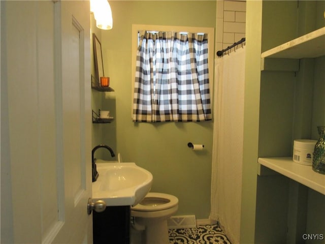 bathroom featuring tile patterned flooring, sink, and toilet