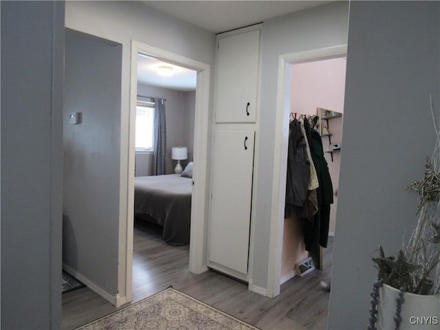 hallway with light hardwood / wood-style flooring