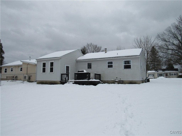 snow covered property with cooling unit