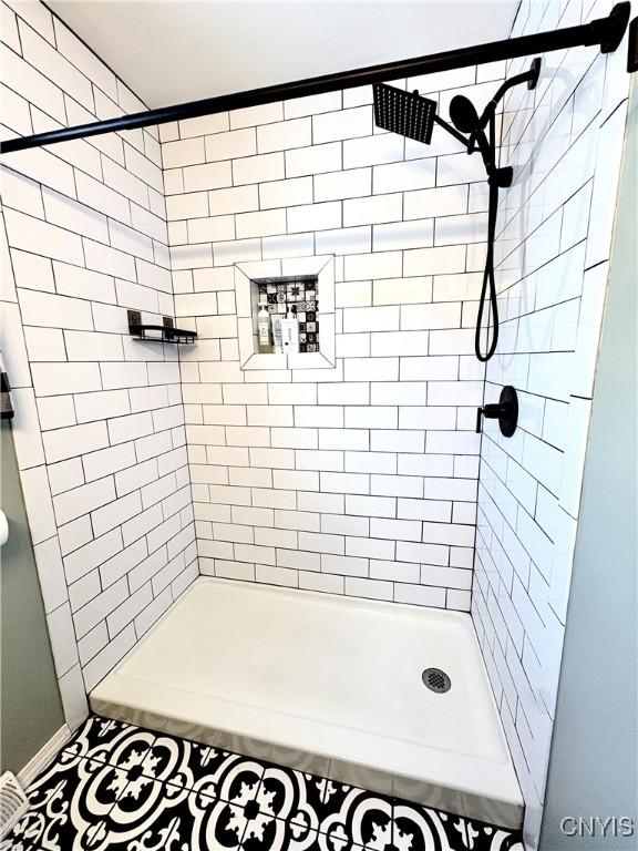 bathroom with a tile shower