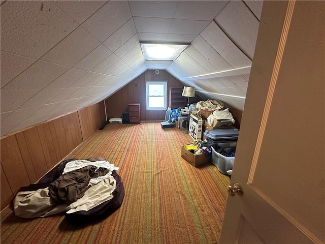 bonus room featuring lofted ceiling, wooden walls, and light colored carpet