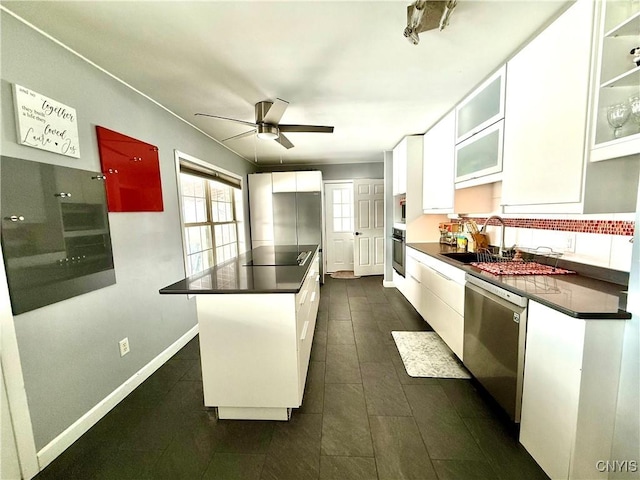 kitchen with ceiling fan, appliances with stainless steel finishes, sink, and white cabinets