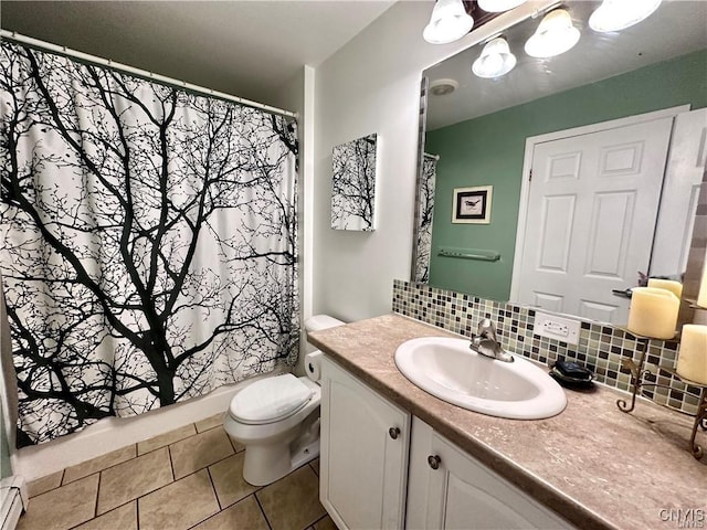 bathroom with walk in shower, toilet, vanity, tile patterned flooring, and backsplash