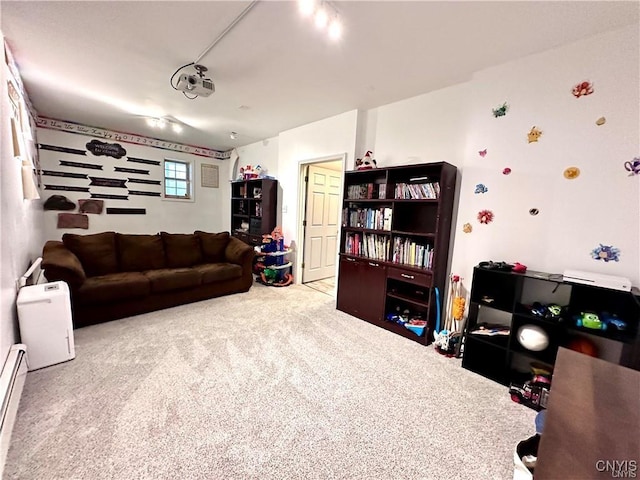 carpeted living room with a baseboard heating unit