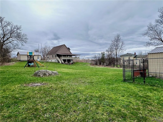 view of yard featuring an outbuilding and a playground