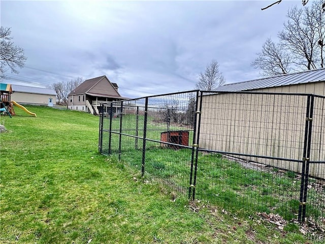 view of yard with an outdoor structure and a playground