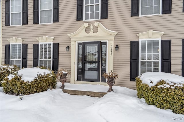 view of snow covered property entrance