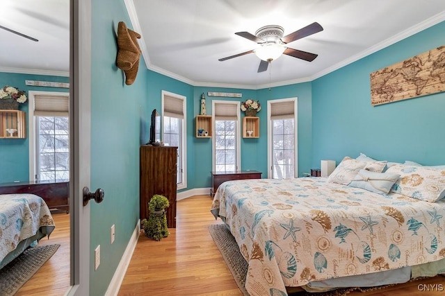 bedroom with ornamental molding, light hardwood / wood-style floors, and ceiling fan