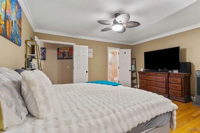 bedroom featuring light hardwood / wood-style flooring, ornamental molding, ceiling fan, and ensuite bathroom