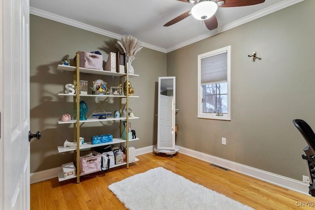 interior space featuring ornamental molding, hardwood / wood-style floors, and ceiling fan