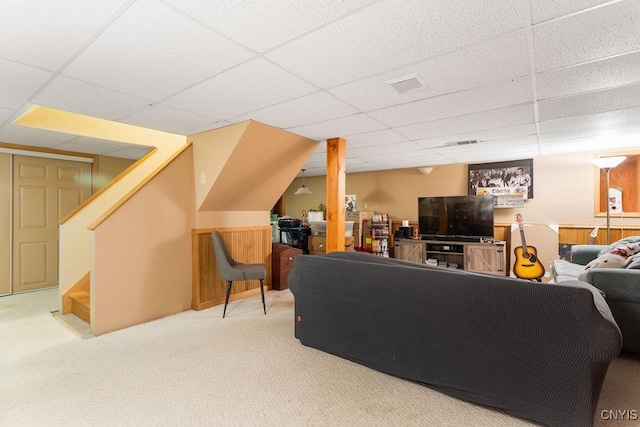 living room with carpet flooring and a drop ceiling