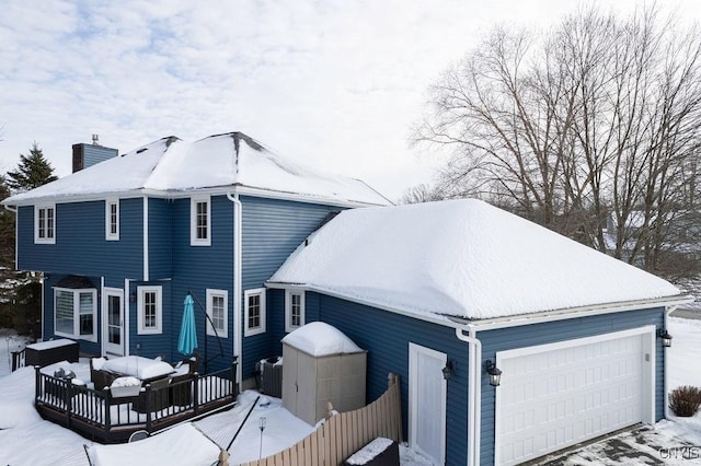 view of snow covered rear of property