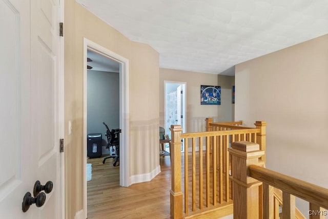 hallway with light hardwood / wood-style flooring