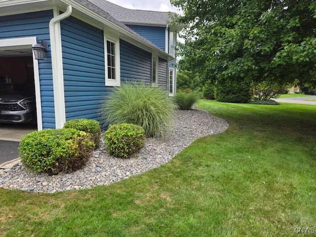 view of side of home with a lawn