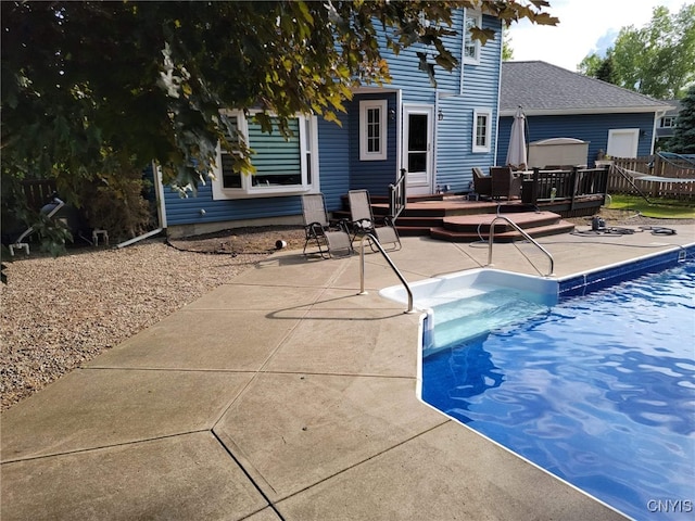 view of pool featuring a wooden deck and a patio area