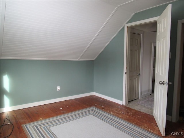 bonus room with lofted ceiling and light wood-type flooring