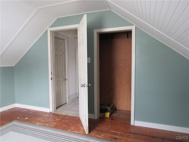 additional living space with vaulted ceiling and hardwood / wood-style floors