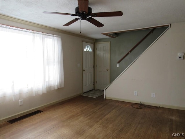 entrance foyer with hardwood / wood-style floors, a textured ceiling, and ceiling fan