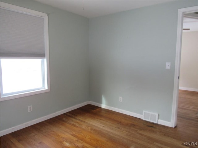 unfurnished room featuring hardwood / wood-style flooring