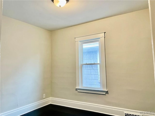 empty room with hardwood / wood-style flooring