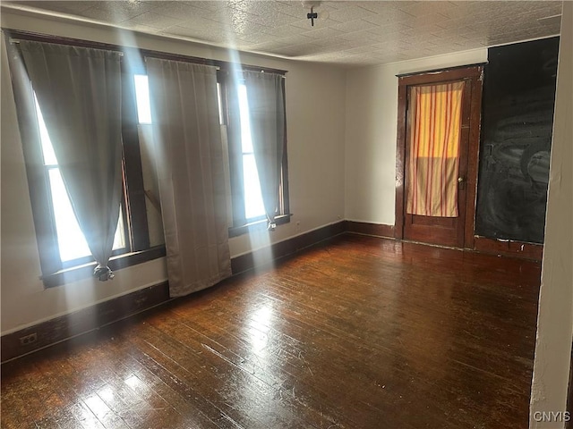 empty room featuring dark hardwood / wood-style flooring