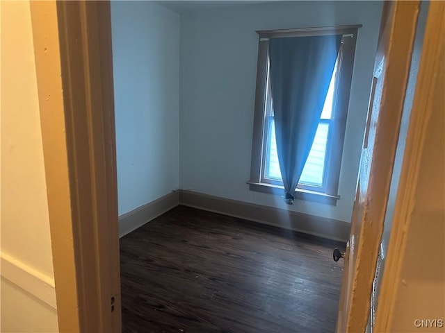 empty room with dark hardwood / wood-style floors