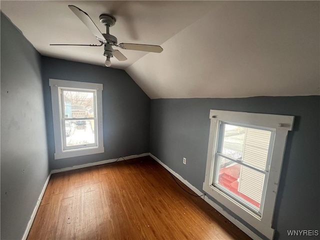 bonus room with hardwood / wood-style flooring, vaulted ceiling, and ceiling fan