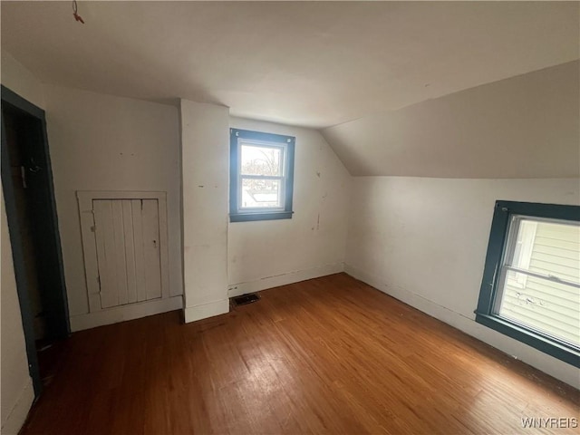 bonus room featuring lofted ceiling and hardwood / wood-style floors