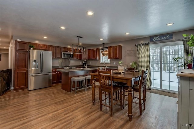 dining space with hardwood / wood-style flooring and sink