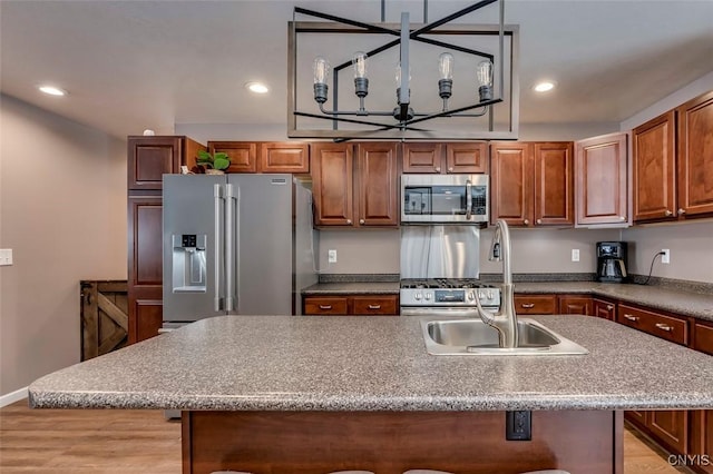 kitchen with stainless steel appliances, a breakfast bar area, a center island, and sink