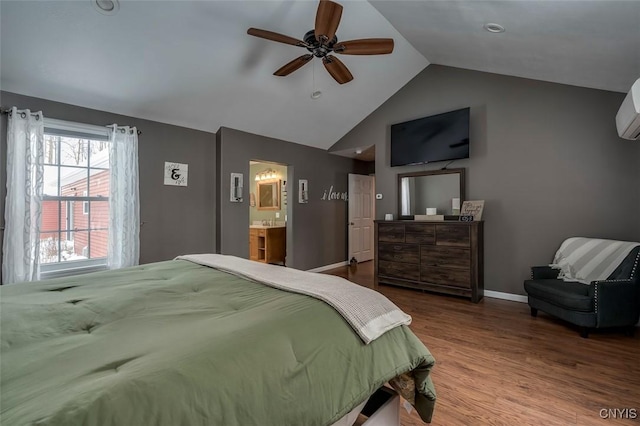 bedroom with ceiling fan, lofted ceiling, wood-type flooring, and ensuite bathroom