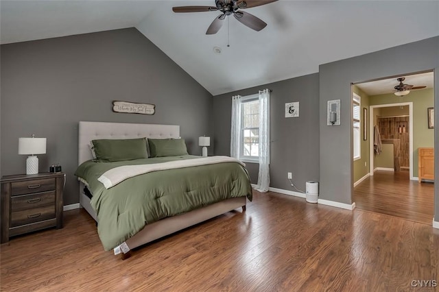 bedroom featuring hardwood / wood-style floors, vaulted ceiling, and ceiling fan