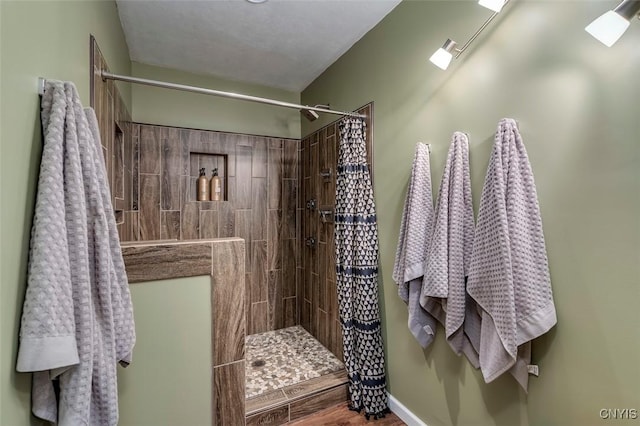 bathroom with a tile shower