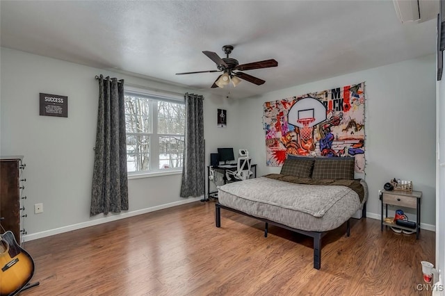 bedroom with ceiling fan and wood-type flooring