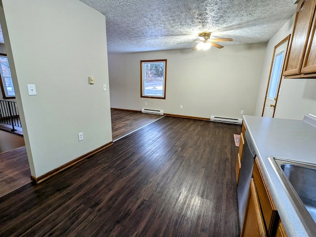 interior space featuring dark hardwood / wood-style flooring, a baseboard heating unit, a textured ceiling, and ceiling fan