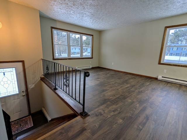 interior space featuring a baseboard radiator, dark hardwood / wood-style floors, and a textured ceiling