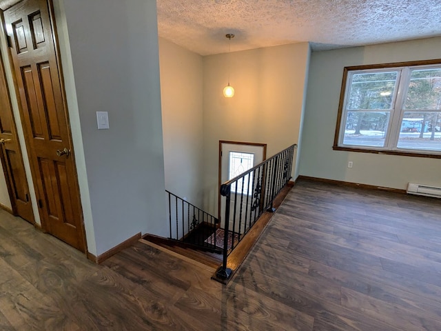 stairway featuring hardwood / wood-style flooring and a textured ceiling