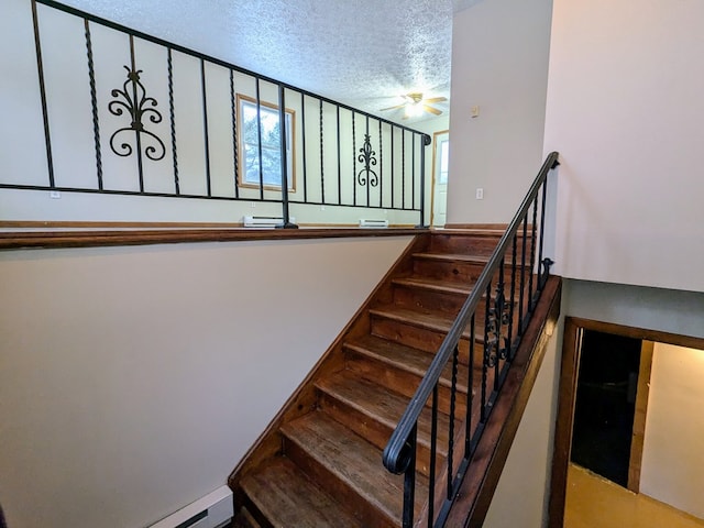 stairway with a healthy amount of sunlight and a textured ceiling