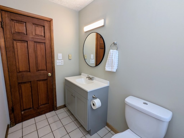 bathroom with vanity, tile patterned floors, a textured ceiling, and toilet