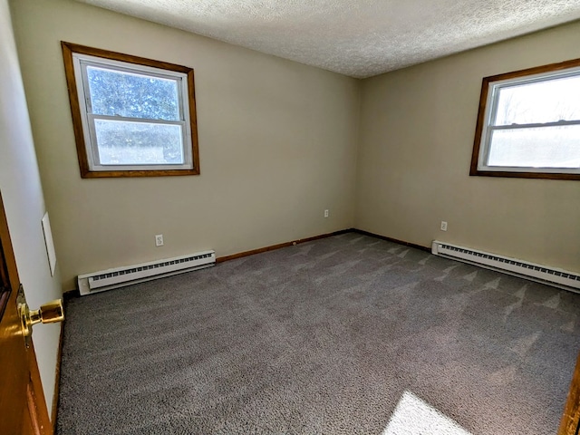 empty room with carpet floors, a textured ceiling, and baseboard heating