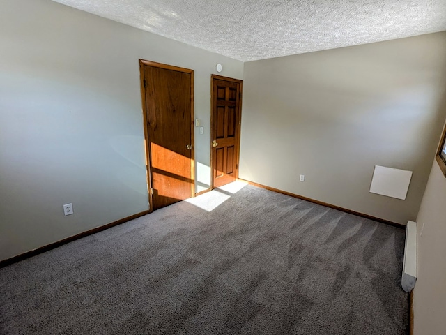 unfurnished room with carpet floors and a textured ceiling