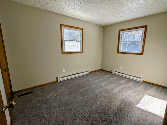 spare room featuring a baseboard radiator, carpet floors, and a textured ceiling