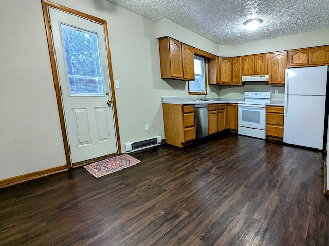 kitchen featuring dark wood-type flooring, sink, a textured ceiling, and white appliances