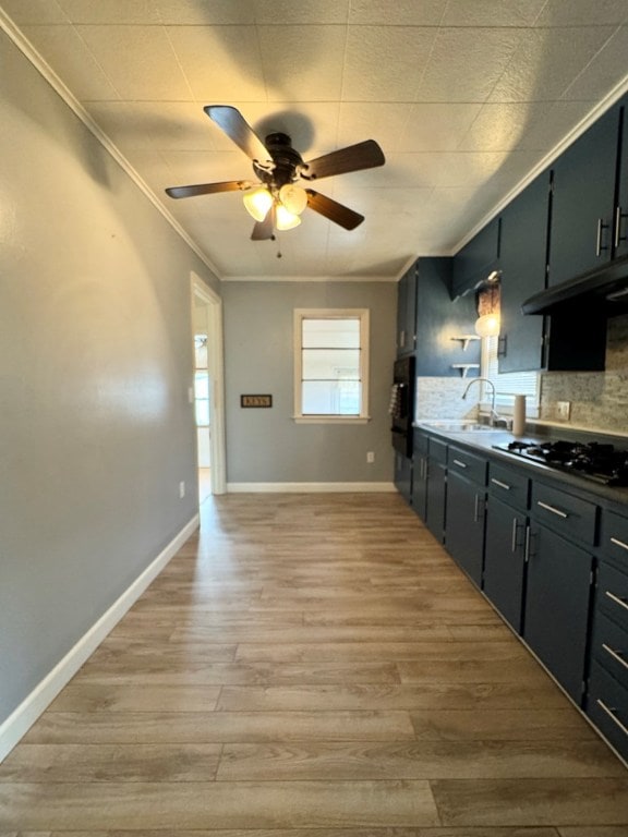 kitchen with crown molding, sink, gas cooktop, and light hardwood / wood-style floors